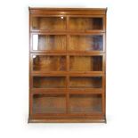 An early 20th century oak sectional bookcase comprising of five glazed bookcase sections,