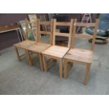 A set of four modern pine high back dining chairs