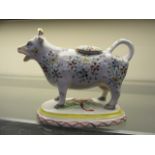 A ceramic creamer in the form of a cow