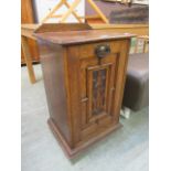 A carved oak cabinet with pull down front