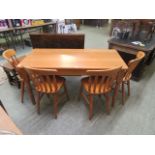 A modern oak rectangular dining table with a set of four similar modern dining chairs