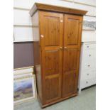 A modern pine two door wardrobe