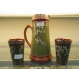 A Victorian silver collared jug along with two matching beakers