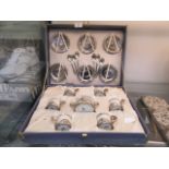 A cased Weidmann tea set with white metal spoons, saucers,