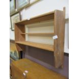 A waxed pine wall mounted shelving unit