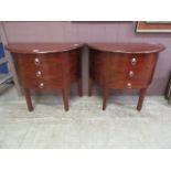 A pair of reproduction demi-lune hall chests having three drawers