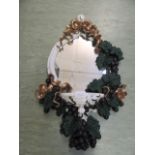 A moulded mirror with shelf below and grape design to frame CONDITION REPORT:
