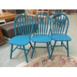 A set of three turquoise painted spindle back dining chairs