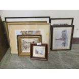 An assortment of framed and glazed prints of various subjects