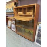 A mid-20th century oak bureau having pull down flap with glazed doors below