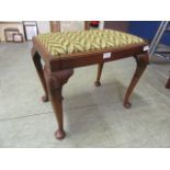 An early 20th century walnut stool with cabriole supports