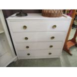 A white painted chest of four drawers