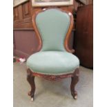 A Victorian walnut nursing chair,