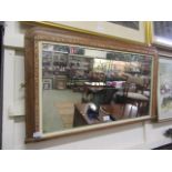 An early 20th century walnut and parquetry banded over mantle mirror