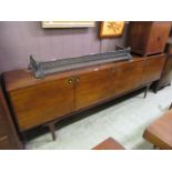 A mid-20th century mahogany and teak veneered sideboard by Everest comprising of four cupboard