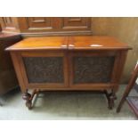 A 19th century walnut cabinet converted to media cabinet with carved panels CONDITION