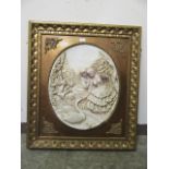 An oval moulded relief panel of courting couple feeding swan in ornate frame