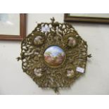 Five ceramic plaques painted with courting couples in a pierced and cast brass frame