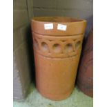 A terracotta chimney pot with Vetruvian scroll detailed band