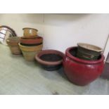 A selection of garden pots to include red glazed, terracotta,
