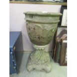 A composite stone garden pot on nautical themed stand