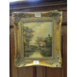 An ornate gilt framed oil on board of river by cottage scene signed bottom right