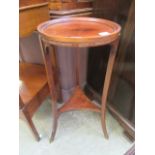 An Edwardian mahogany and boxwood strung jardiniere stand