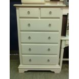 A modern white chest of two short over four long drawers