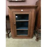 A 19th century oak wall hanging corner cupboard with glazed door