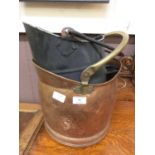 A copper and brass coal bucket along with another scuttle and tongs