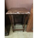 An early 20th century oak occasional table on barley twist legs