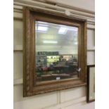 An ornate gilt framed bevel glass mirror