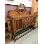 An early 20th century oak sideboard, octagonal bevel glass mirror over two central drawers flanked