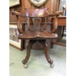 A 19th century walnut swivel tub chair