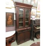 A 19th century mahogany bookcase, the glazed arch doors over single drawer and cupboard doors