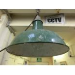 An industrial green enameled ceiling hanging lamp
