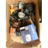 A box containing an assortment of cameras and accessories