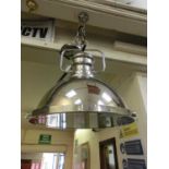 An industrial styled chromed ceiling hanging lamp