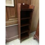 An early 20th century walnut slimline open bookcase