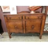 An early 20th century oak sideboard, two drawers over cupboard doors