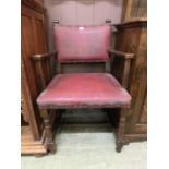 An early 20th century beech framed open armchair upholstered in red leatherette fabric