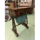 A Victorian mahogany work table, the fold over top supported on swivel action over single drawer and