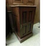 An early 20th century walnut pot cupboard with quadruple paneled door on plinth base