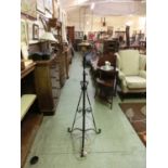 A 19th century wrought iron lamp stand converted to electricity