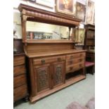 An early 20th century oak mirror back dresser, the beveled plate with Corinthian columned support