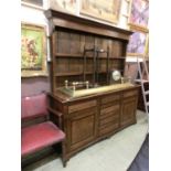 An early 20th century oak and mahogany banded dresser, the plate rack over the base with three