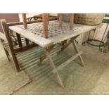 A weathered teak folding garden table