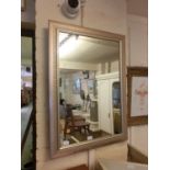 A modern flamed rectangular wall mirror