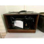 A cased Singer manual sewing machine