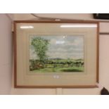 A framed and glazed watercolour of countryside from garden signed bottom right